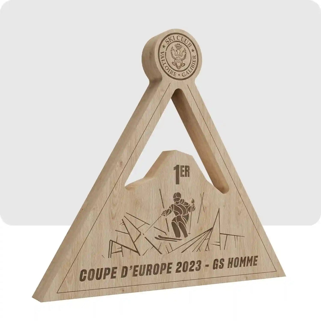 Trophée en bois en forme de triangle avec le nom de la compétition au centre du trophée. 