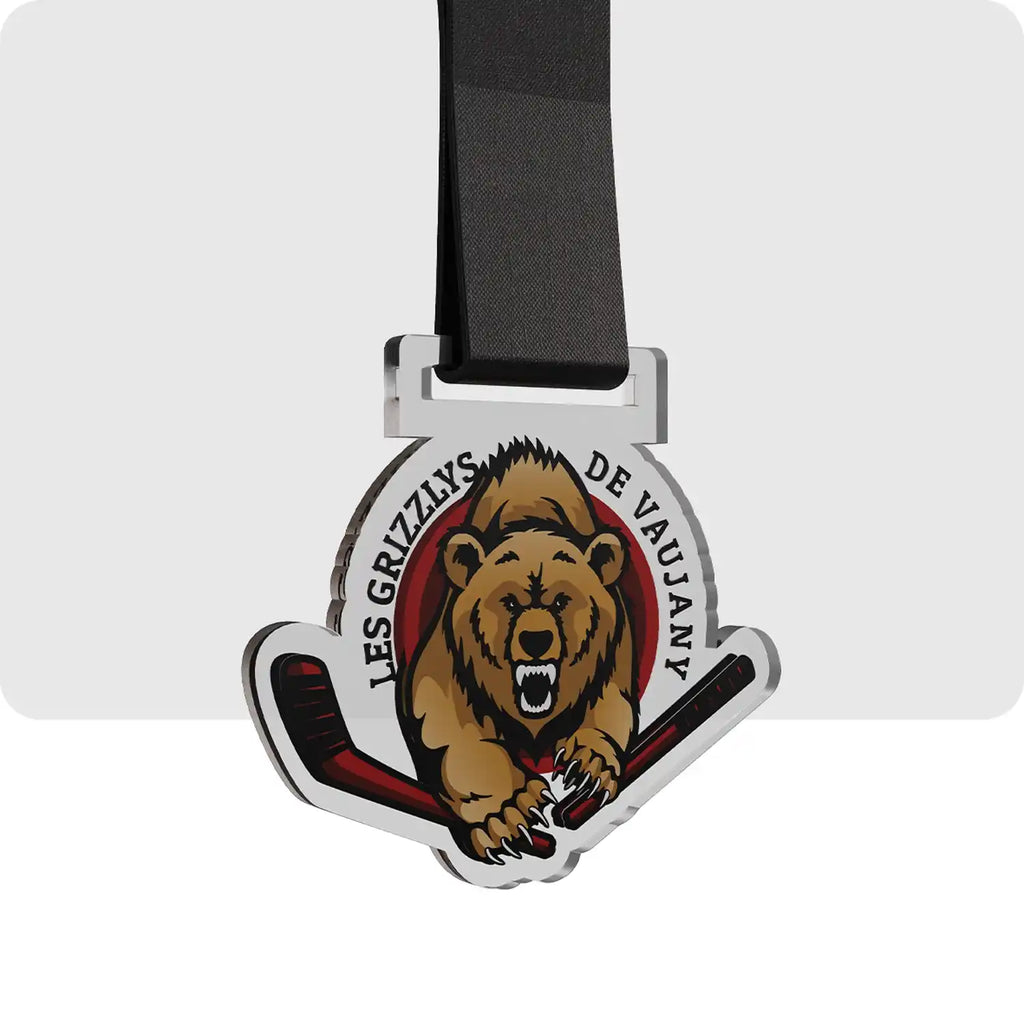 médaille en plastique représentant en son centre un grizzly, pour l'équipe de hockey de Vaujanx.