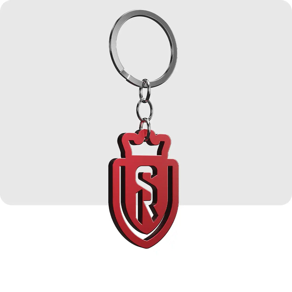 Porte clé gravé de couleur rouge. Sa forme représente le logo de l'équipe de football du Stade de Reims. 